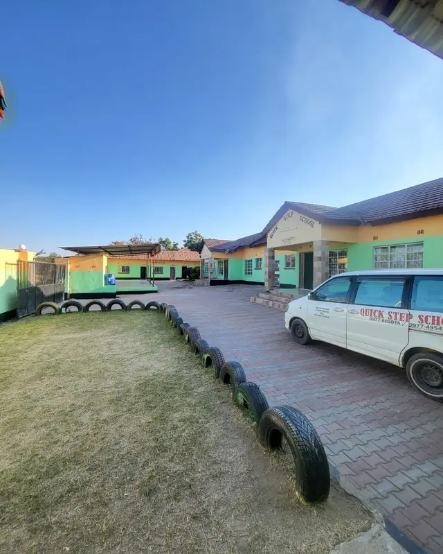 The Meanwood campus courtyard and classroom blocks, with the school bus parked inside