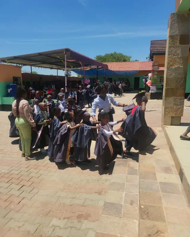 Teachers and families with pupils at a Quick Step graduation ceremony