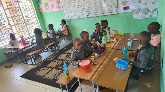 Pupils at their desks during snack time at the PHI campus